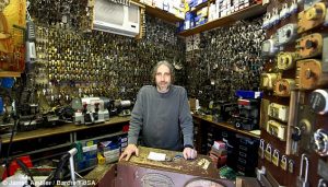 Phil Mortillaro inside his Locksmith Shop in front of Thousands of Keys