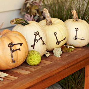 Skeleton Keys Spelling out the Word "Fall" on Four Pumpkins