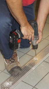 Expert locksmith installing a new threshold