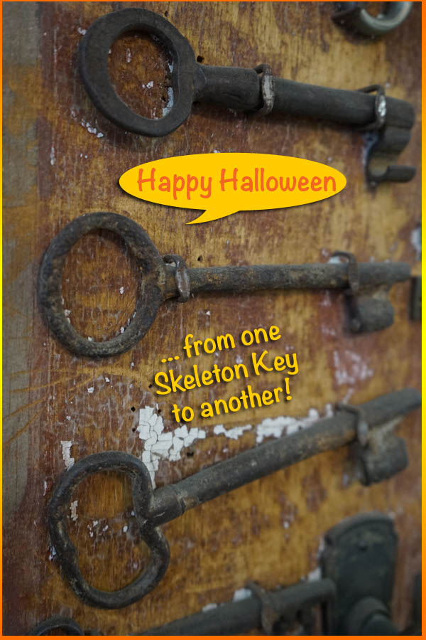 Rusted Old Skeleton Keys Hung Up Against a Wall with "Happy Halloween, from One Skeleton Key to Another" Text Overlay