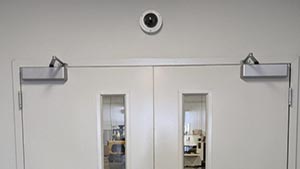 Security camera mounted above double doors